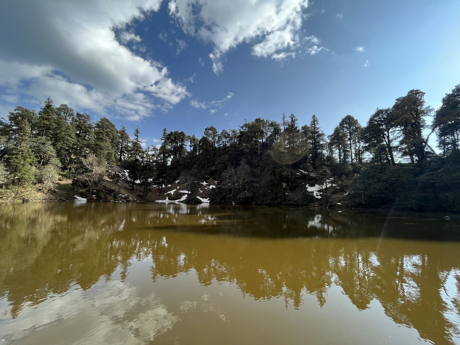 A lake ringed by forest on the Brahmatal trail