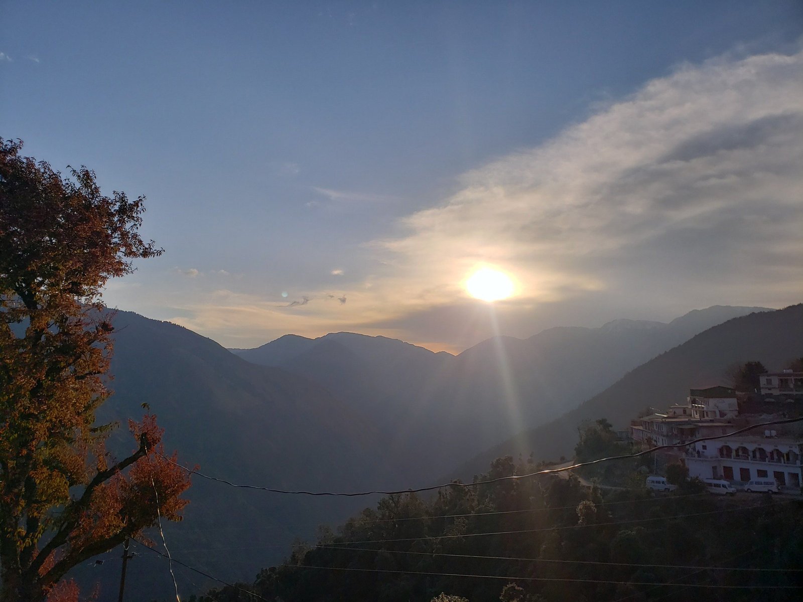 Early sun over the valley, with houses on the hillside